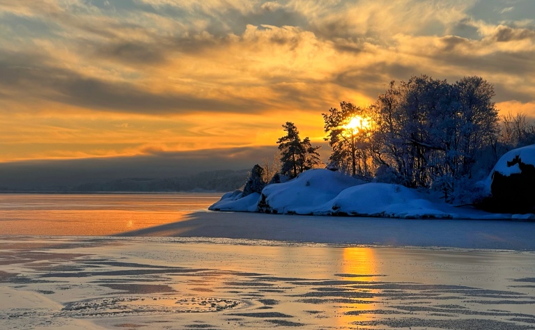 Picture of sunset over the water. The water is frozen. The purpose for the image is to illustrate how importent light is to the photo. 

